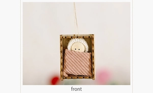Close-up of a handmade wooden Christmas doll ornament with knit hat in a box frame