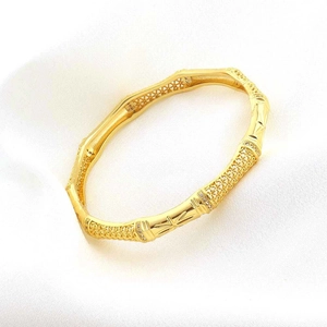 18K gold plated bamboo link bangle with pave zircons and intricate cutout leaf patterns