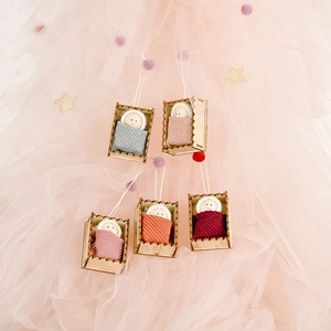 Five handmade Christmas wooden peg doll pendants in colorful knitted blankets and cradles