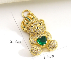 Detail view of gold-plated bear pendant with green heart stone and size measurements