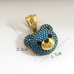 Detailed size view of a gold-plated bear pendant with blue beads and zircon stones