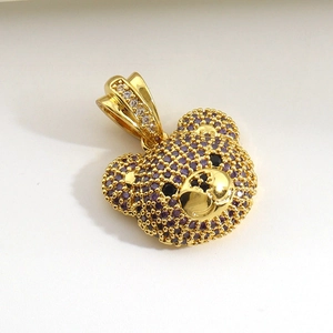 Charming gold-plated bear pendant encrusted with vibrant purple and black cubic zirconia