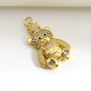 Macro shot of gold plated teddy bear pendant with crown and micro-set cubic zirconia crystals