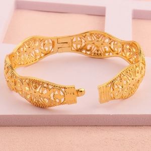 Detail van 18k vergulde holle armband met vintage gegraveerd patroon en sluiting