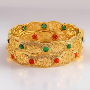 Detail of 18K gold plated cuff bracelet with hollow filigree and colorful zircon stones