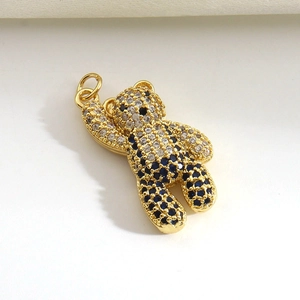 Detailed view of a gold-plated bear pendant with micro-paved blue and white zircon stones