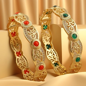 Detail of 18K gold-plated open bangles with hollow patterns and zircon inlay