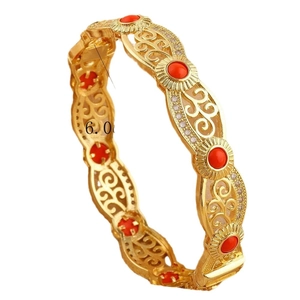 Hollow gold bracelet with red gemstone inlay and white crystal accents in palace style