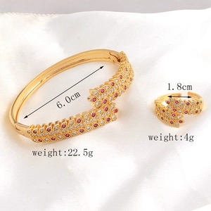 Detail shot of gold jewelry set showing weight and size for ring and bangle with red stones