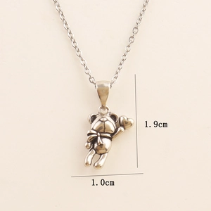 Detailed view of vintage silver bear pendant necklace with 1.9cm height measurements