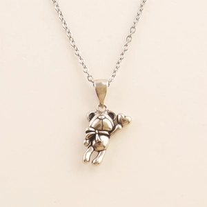 Vintage style teddy bear pendant necklace with heart detail and adjustable cross chain