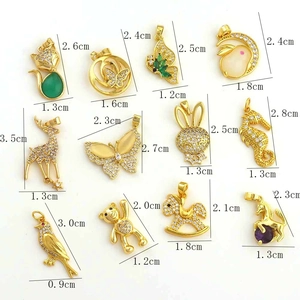 Detailed grid of gold butterfly and animal charms with zircon and opal stones