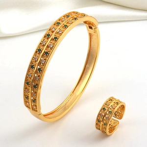 Detail of gold-plated jewelry set featuring hollow patterns and sparkling cubic zirconia