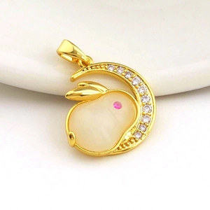 Macro shot of gold rabbit moon pendant with white jade inlay and micro-paved zircons