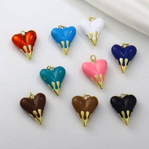 Close-up of colorful heart pendants with drip glaze finish and gold-plated fluid metal details