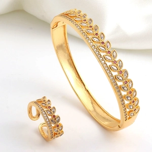 Detail of gold-plated wheat leaf jewelry set with red and white cubic zirconia accents