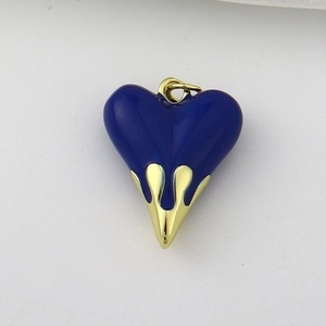 Detail of heart pendant with dark blue enamel and gold-tone liquid metal drip design