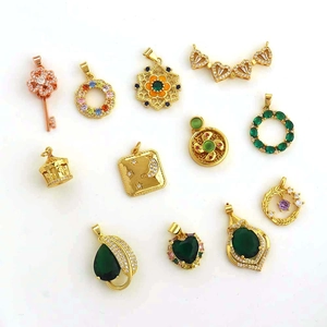 Detailed assortment of 18k gold plated charms featuring colorful cubic zirconia and gems