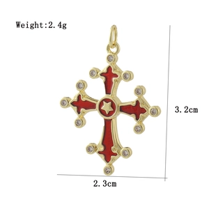 Macro detail of 18k gold plated cross pendant with red enamel and zircon stones
