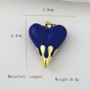 Detail view of a 2.4cm blue heart pendant with gold drip accent and size measurements
