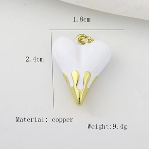 Detail view of heart pendant with white enamel surface and gold copper casing