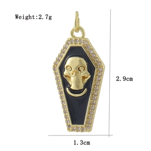 Detailed view of 18k gold plated coffin pendant with skull emblem and zircon border