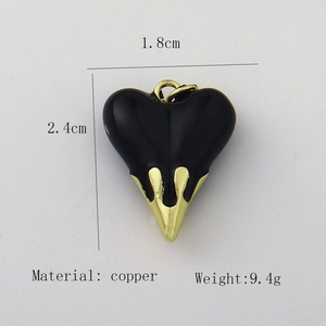 Detailed view of 2.4cm black heart pendant with gold copper trim and weight specs