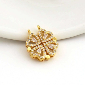 Close-up of a rotating clover pendant with 18k gold plating and micro-set zircons