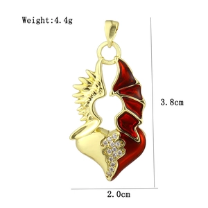 Detail view of heart pendant with angel wing and red devil wing featuring cubic zirconia