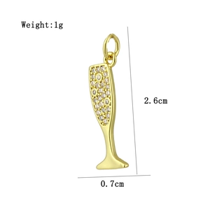 Macro shot of gold champagne glass pendant with inlaid zircons weighing 1g and 2.6cm high