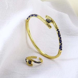 Detail van de 18k vergulde sieradenset met blauw email op de armband en de ring