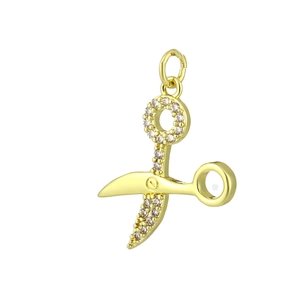Detailed view of a gold scissor pendant with micro-pave cubic zirconia crystals