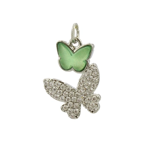 Macro shot of silver butterfly charm with green enamel and sparkling zircon stones