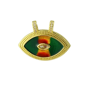 Detail of eye-shaped gold pendant featuring green enamel and marquise cubic zirconia