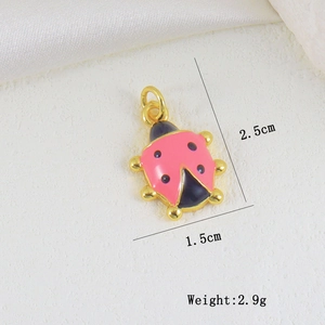 Pink enamel ladybug jewelry pendant with gold metal base and dimensions 2.5cm x 1.5cm
