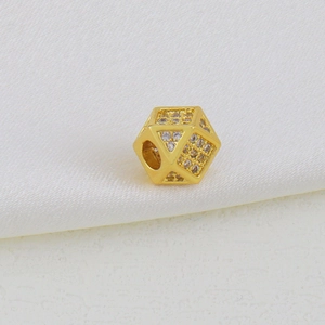 Macro shot of gold-plated hexagonal charm with micro-paved cubic zirconia for DIY jewelry