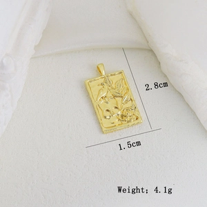 Detail of a gold rectangular pendant with skull and bird relief, 2.8cm x 1.5cm size