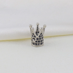 Detailed macro view of silver crown charm with micro-set black cubic zirconia for DIY jewelry