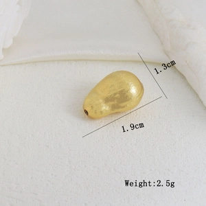 Close-up of golden teardrop DIY bead with brushed texture, dimensions 1.9cm by 1.3cm