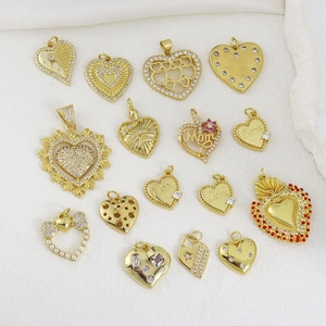 Macro shot of assorted heart-shaped charms with cubic zirconia and gold-plated details