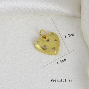 Detailed view of heart-shaped gold pendant with cubic zirconia inlay and 1.7cm height