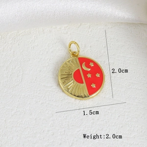 Detail shot of celestial enamel pendant with size guide 2cm on white silk background
