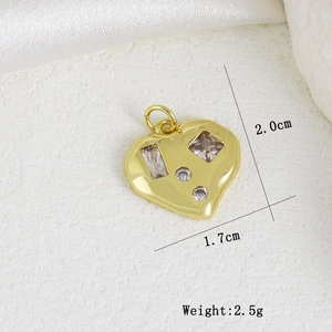 Macro shot of gold heart pendant with cubic zirconia inlay and size measurements