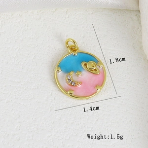 Detail view of round enamel star and moon pendant with dimensions 1.8cm by 1.4cm