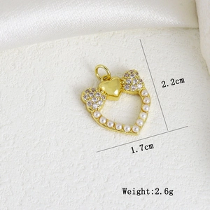 Detail of heart pendant with bow and pearls showing dimensions 2.2cm height and 1.7cm width