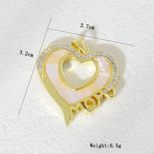 Detail view of a gold heart pendant with MOM lettering and shimmering shell inlay