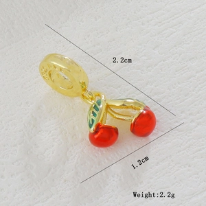 Detailed view of gold plated cherry pendant with red enamel and S925 silver stamp