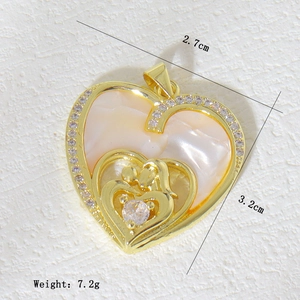 Detail of copper heart pendant with mother of pearl inlay and crystal accents