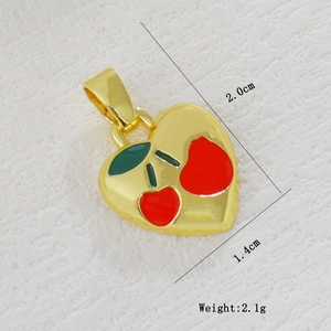 Detail showing 2.0x1.4cm dimensions of gold heart charm with red cherry enamel pattern
