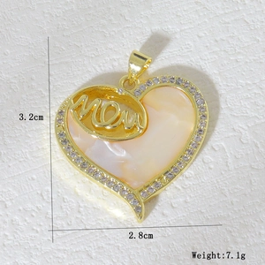 Detailed view of gold heart pendant with Mom lettering, shell inlay and white zircon stones